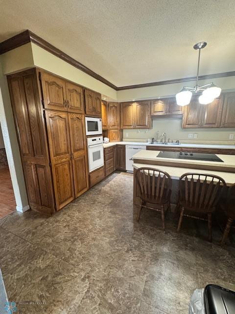 214 7th St, Hatton, ND 58240 - kitchen featuring white appliances, crown molding, a textured ceiling, brown cabinets, and light countertops
