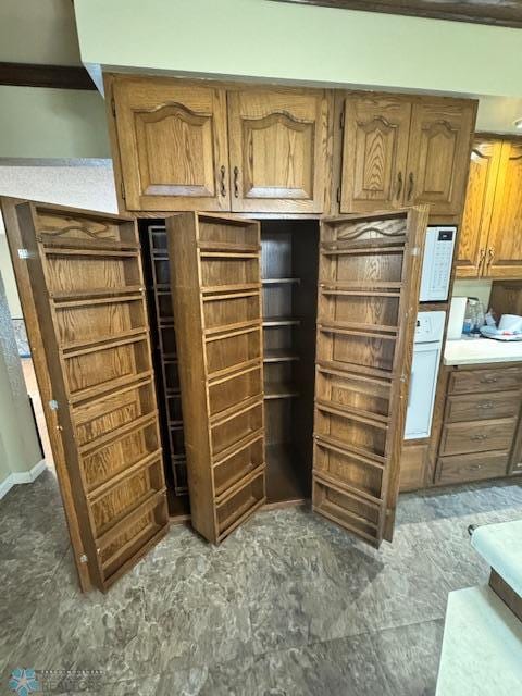214 7th St, Hatton, ND 58240 - kitchen featuring brown cabinets, light countertops, and oven