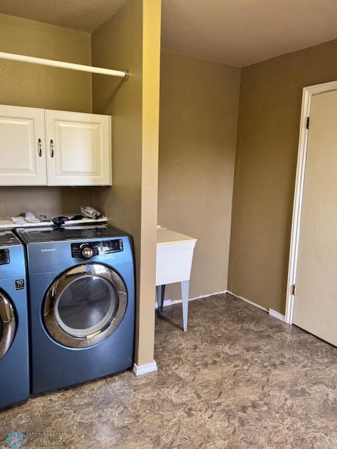 214 7th St, Hatton, ND 58240 - washroom featuring washer and clothes dryer and cabinet space
