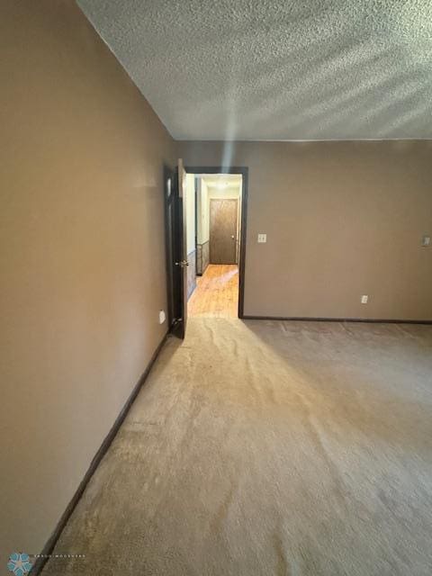 214 7th St, Hatton, ND 58240 - spare room featuring a textured ceiling and light colored carpet
