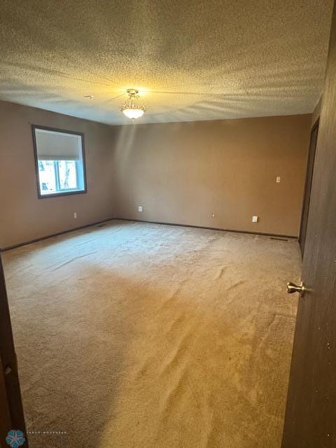 214 7th St, Hatton, ND 58240 - spare room featuring light carpet and a textured ceiling