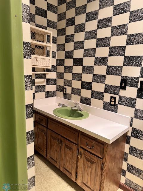 214 7th St, Hatton, ND 58240 - bathroom with vanity and decorative backsplash