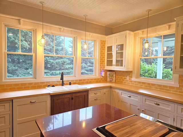 1504 4th St NE, Willmar, MN 56201 - kitchen with glass insert cabinets, backsplash, pendant lighting, and plenty of natural light