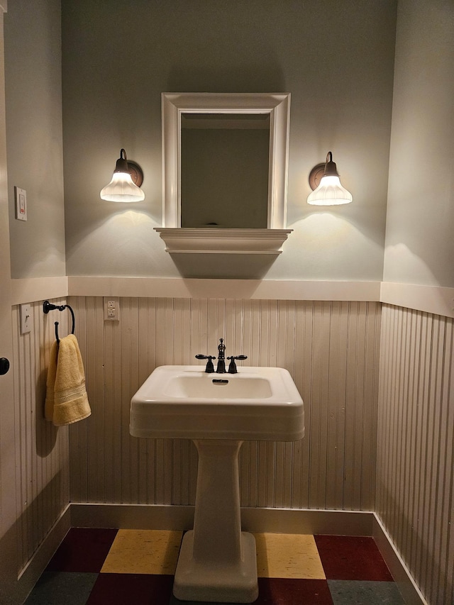 1504 4th St NE, Willmar, MN 56201 - bathroom featuring a wainscoted wall and wooden walls