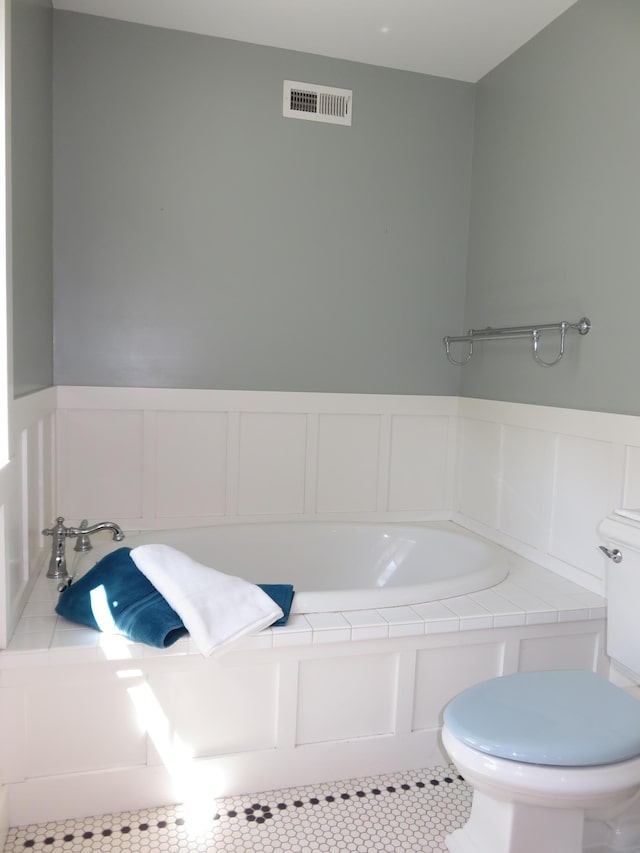 1504 4th St NE, Willmar, MN 56201 - bathroom with tile patterned floors and wainscoting