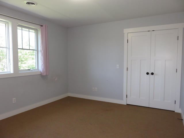 1504 4th St NE, Willmar, MN 56201 - unfurnished bedroom featuring carpet floors and a closet