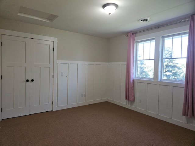 1504 4th St NE, Willmar, MN 56201 - unfurnished bedroom with wainscoting and carpet
