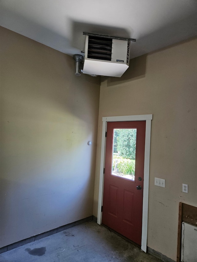 1504 4th St NE, Willmar, MN 56201 - doorway to outside featuring unfinished concrete floors and a heating unit