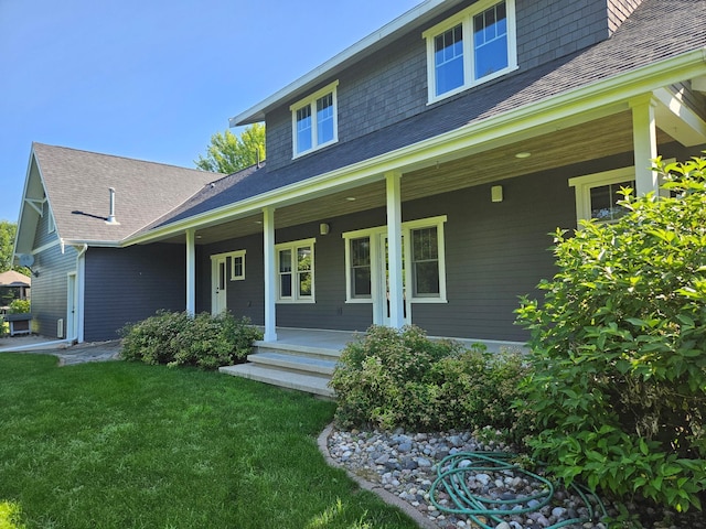1504 4th St NE, Willmar, MN 56201 - view of front of property with covered porch, a front lawn, and a shingled roof