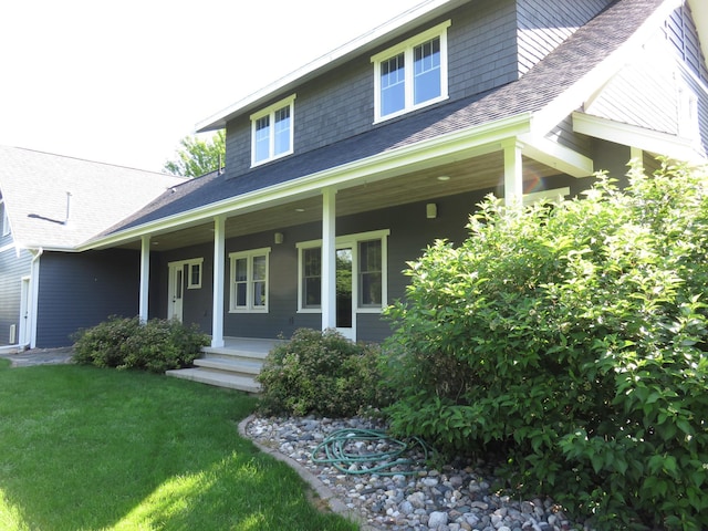 1504 4th St NE, Willmar, MN 56201 - view of front of property featuring covered porch, a front lawn, and roof with shingles