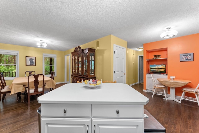 7535 335th Ave NW, Princeton, MN 55371 - kitchen featuring a textured ceiling, dark wood-style flooring, a center island, and light countertops