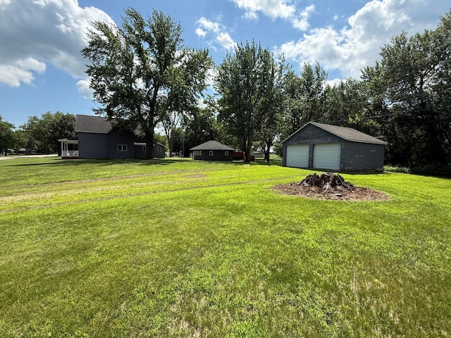 681 8th St, Walnut Grove, MN 56180 - view of grassy yard featuring a detached garage and an outbuilding