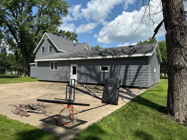 681 8th St, Walnut Grove, MN 56180 - rear view of house featuring a lawn and roof with shingles