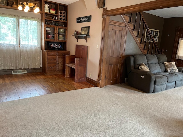 681 8th St, Walnut Grove, MN 56180 - carpeted living room featuring hardwood / wood-style floors and stairs