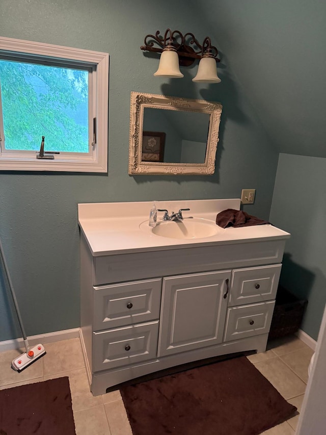 681 8th St, Walnut Grove, MN 56180 - bathroom featuring tile patterned flooring, vanity, and lofted ceiling