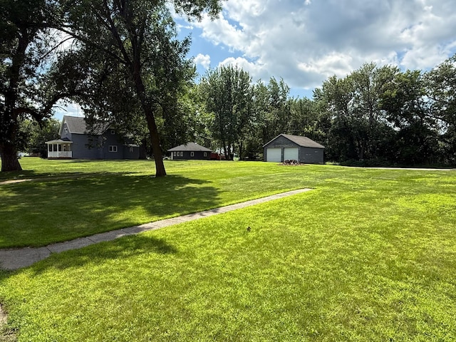 681 8th St, Walnut Grove, MN 56180 - view of green lawn featuring a detached garage
