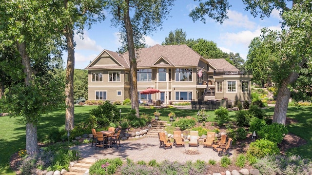 12795 Ozark Trl N, May Twp, MN 55082 - back of property with stairway, a yard, and a patio