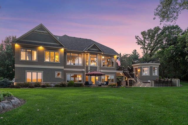 12795 Ozark Trl N, May Twp, MN 55082 - back of property at dusk featuring a lawn