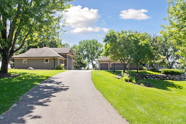 12795 Ozark Trl N, May Twp, MN 55082 - view of front of house featuring a garage, a front yard, and driveway
