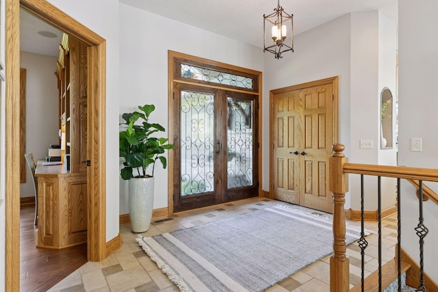 12795 Ozark Trl N, May Twp, MN 55082 - entryway featuring french doors and a chandelier