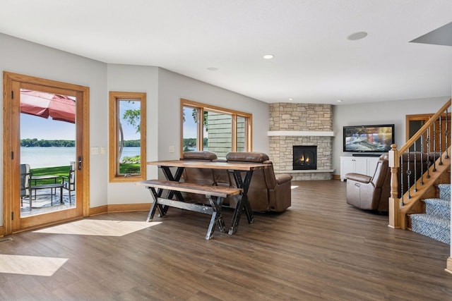 12795 Ozark Trl N, May Twp, MN 55082 - living room featuring wood finished floors, a stone fireplace, stairs, recessed lighting, and a water view