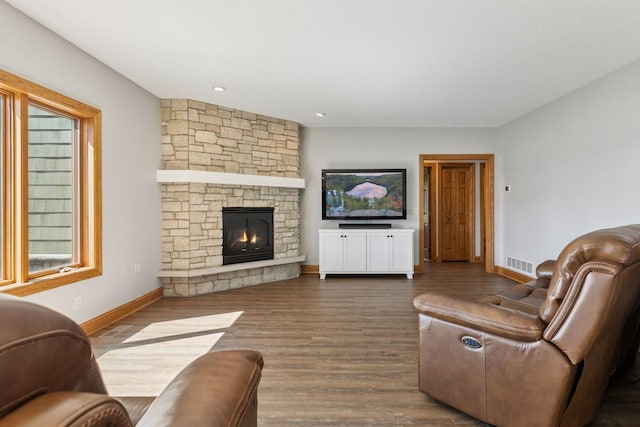 12795 Ozark Trl N, May Twp, MN 55082 - living area featuring a stone fireplace, dark wood-type flooring, and recessed lighting