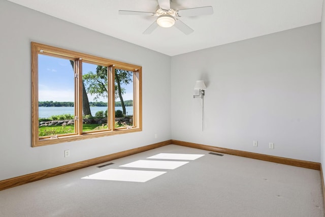12795 Ozark Trl N, May Twp, MN 55082 - empty room with carpet floors, a ceiling fan, and a water view