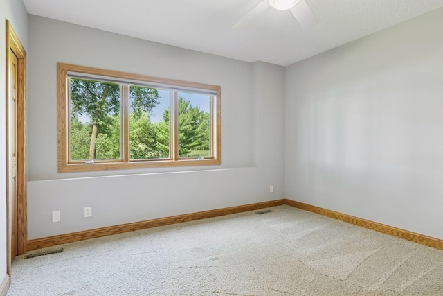 12795 Ozark Trl N, May Twp, MN 55082 - carpeted empty room with ceiling fan and baseboards