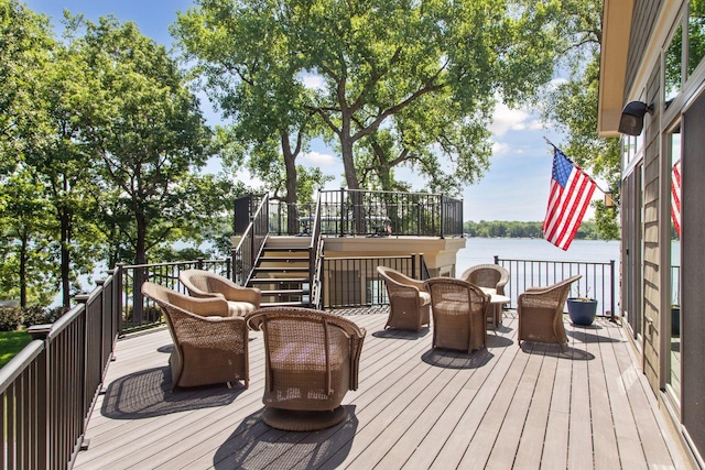 12795 Ozark Trl N, May Twp, MN 55082 - wooden terrace with stairway, a water view, and outdoor dining area