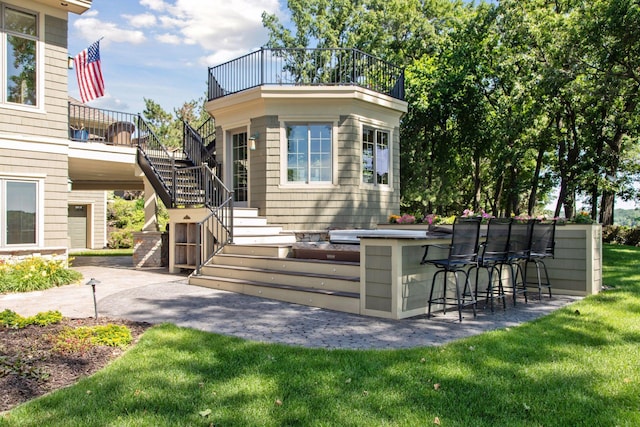 12795 Ozark Trl N, May Twp, MN 55082 - exterior space with stairway, a balcony, a yard, and a patio