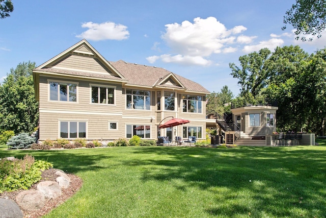 12795 Ozark Trl N, May Twp, MN 55082 - rear view of house with a yard and a patio