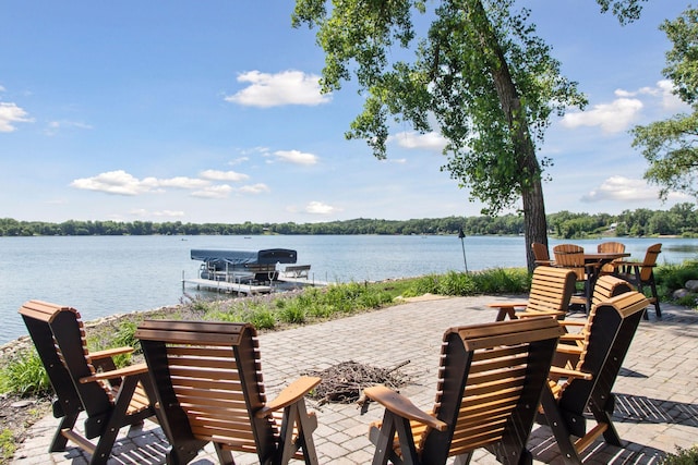12795 Ozark Trl N, May Twp, MN 55082 - view of patio featuring a water view, a dock, and a fire pit