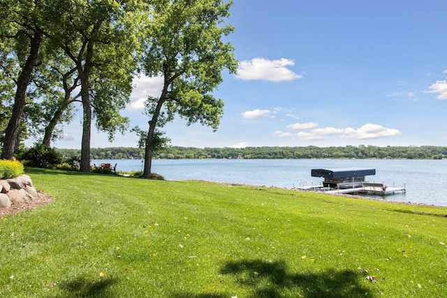 12795 Ozark Trl N, May Twp, MN 55082 - view of grassy yard with a water view, boat lift, and a dock