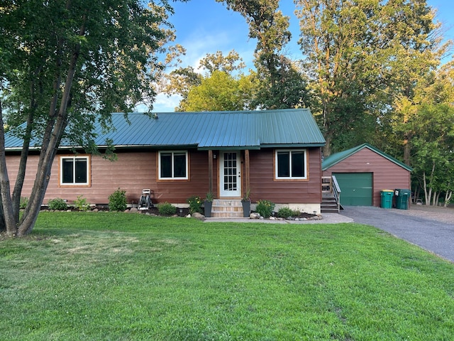 30290 7th Ave N, Swiss Twp, WI 54830 - ranch-style home featuring a detached garage, an outdoor structure, a front yard, asphalt driveway, and a metal roof