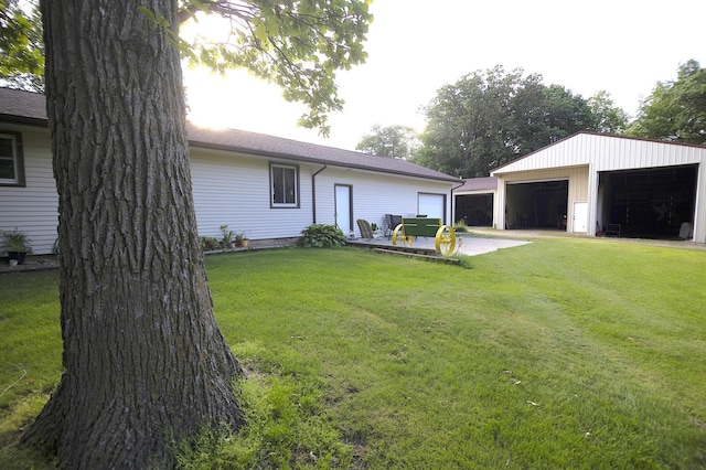 39070 County Highway 67, Newton Twp, MN 56567 - view of front of home featuring a garage, a front yard, and an outbuilding