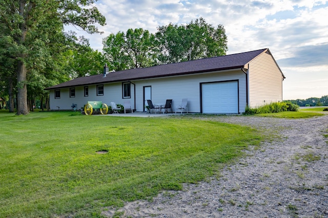 39070 County Highway 67, Newton Twp, MN 56567 - view of front of home featuring an attached garage, a front lawn, gravel driveway, and a patio area