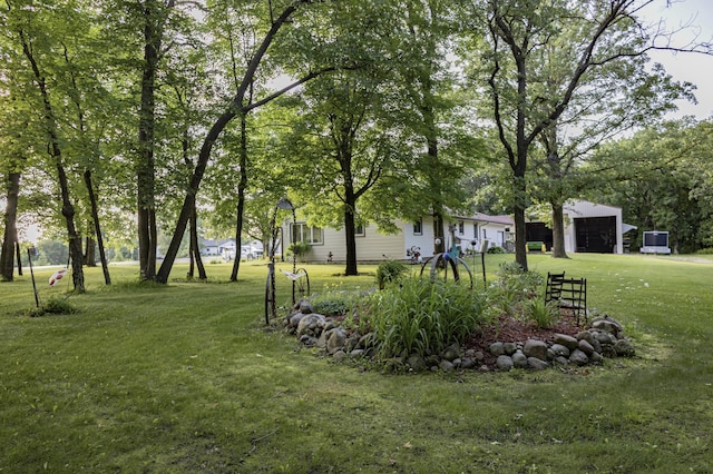 39070 County Highway 67, Newton Twp, MN 56567 - view of green lawn with a garage