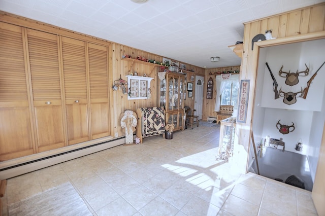 39070 County Highway 67, Newton Twp, MN 56567 - entryway featuring wood walls, light tile patterned floors, and a baseboard radiator