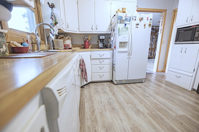 39070 County Highway 67, Newton Twp, MN 56567 - kitchen featuring white appliances, light countertops, white cabinets, and light wood-type flooring