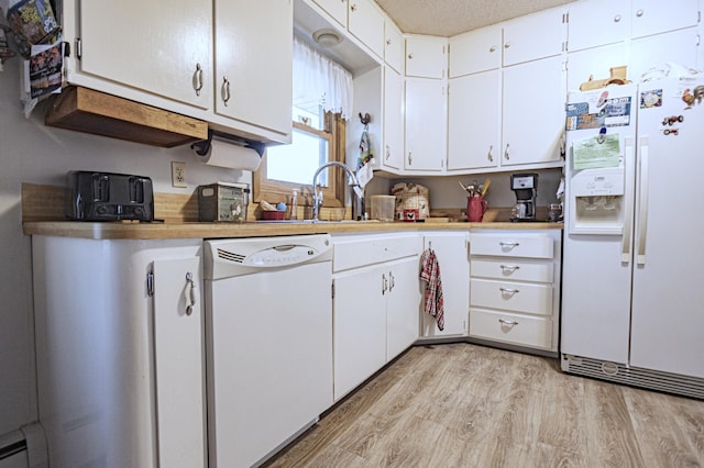 39070 County Highway 67, Newton Twp, MN 56567 - kitchen with white appliances, light countertops, light wood-style flooring, and white cabinets
