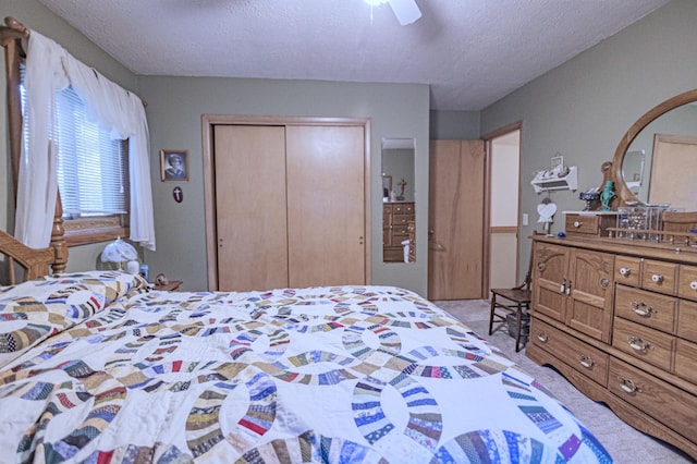 39070 County Highway 67, Newton Twp, MN 56567 - bedroom featuring a closet, light colored carpet, a textured ceiling, and a ceiling fan