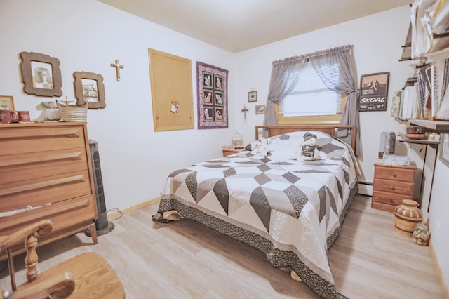 39070 County Highway 67, Newton Twp, MN 56567 - bedroom with light wood-style flooring and a baseboard heating unit