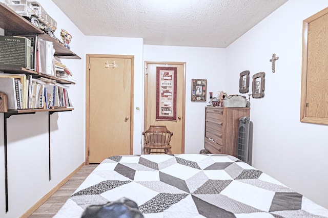 39070 County Highway 67, Newton Twp, MN 56567 - bedroom featuring light wood-type flooring and a textured ceiling