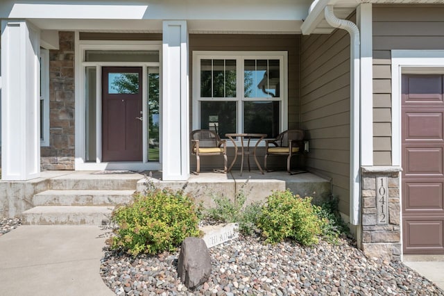 10412 Florida Ave N, Brooklyn Park, MN 55445 - doorway to property featuring covered porch and stone siding