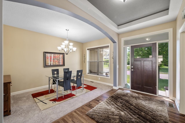 10412 Florida Ave N, Brooklyn Park, MN 55445 - foyer with a chandelier, wood finished floors, and arched walkways