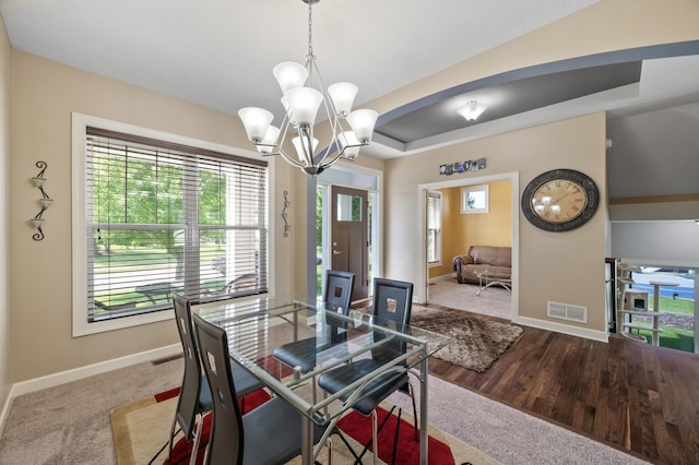 10412 Florida Ave N, Brooklyn Park, MN 55445 - carpeted dining area with a chandelier and a raised ceiling