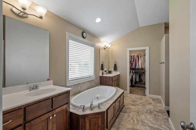 10412 Florida Ave N, Brooklyn Park, MN 55445 - full bathroom with two vanities, lofted ceiling, a bath, and a spacious closet