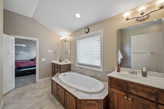 10412 Florida Ave N, Brooklyn Park, MN 55445 - ensuite bathroom with two vanities, lofted ceiling, and a garden tub