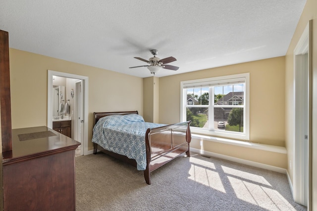 10412 Florida Ave N, Brooklyn Park, MN 55445 - bedroom with carpet flooring, ceiling fan, a textured ceiling, and connected bathroom