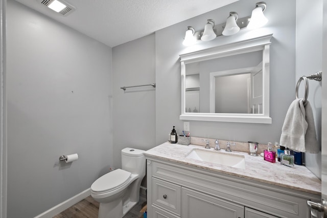 10412 Florida Ave N, Brooklyn Park, MN 55445 - bathroom with vanity, wood finished floors, and a textured ceiling